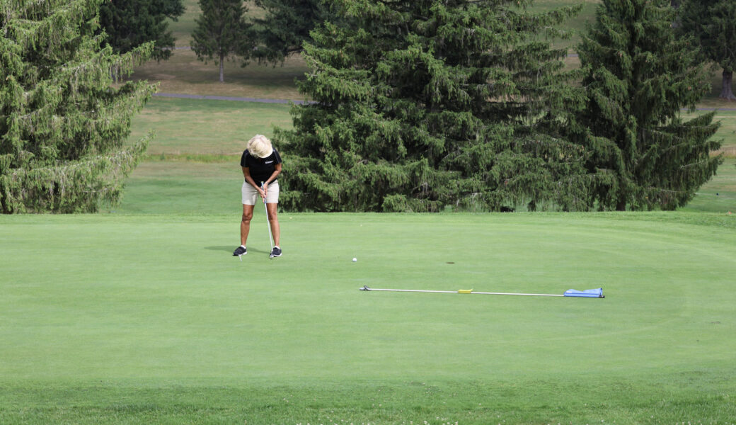 Golfer putting at event