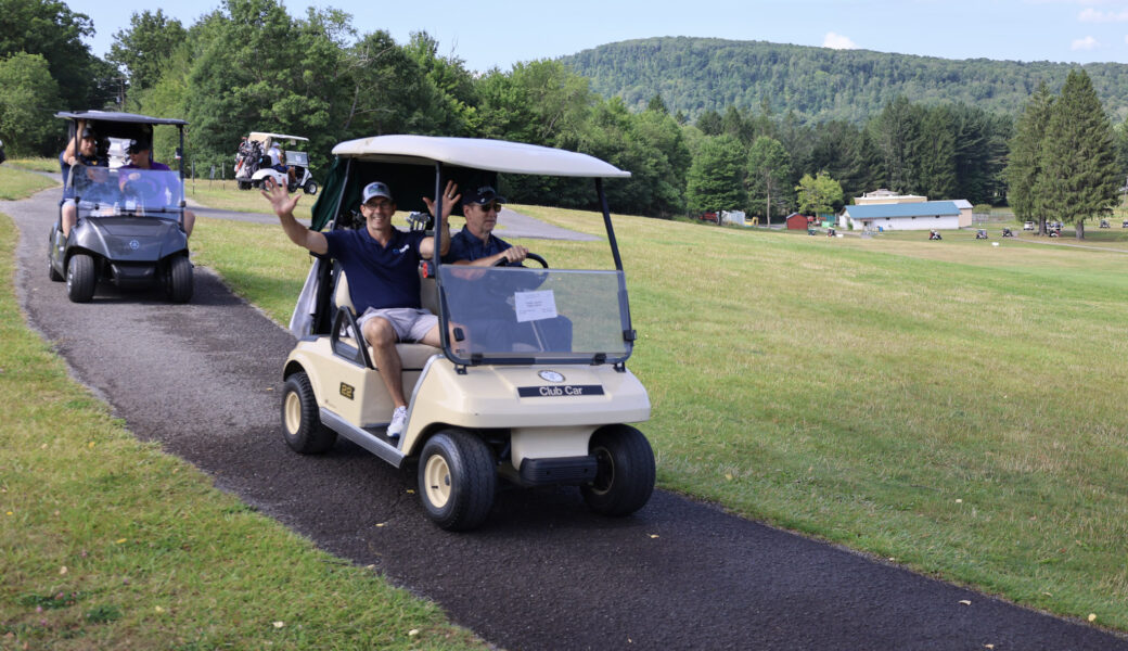 Golf team on carts at event