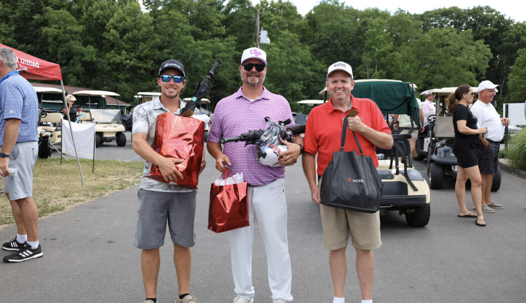 Three prize winners from golf event.