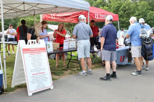 Golfers line up for registration and raffle tickets