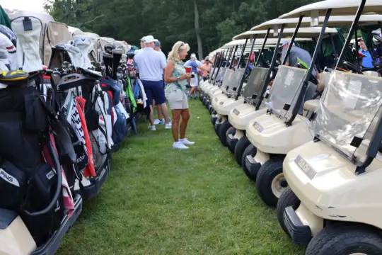 A line of golf carts wait for the start of the tournament