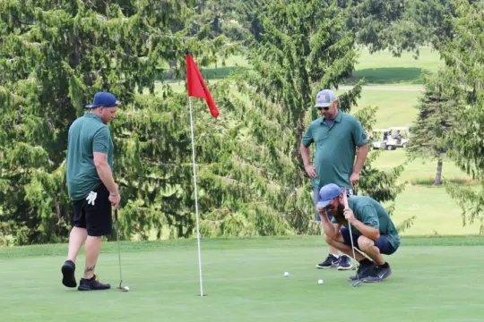 Golfers examine their shot.