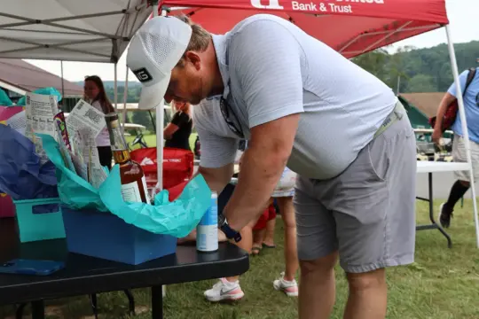 Golf makes a bid on a silent auction.