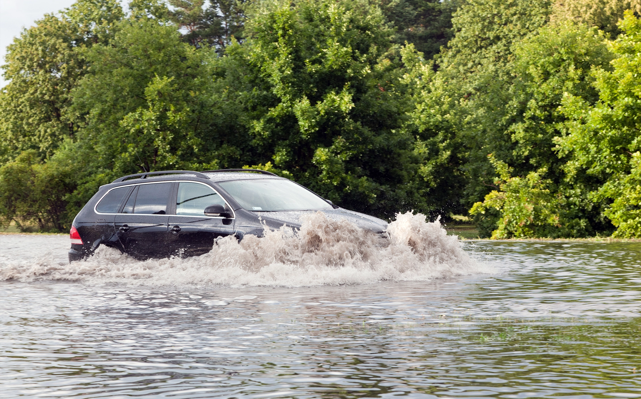 Car driving through flood Car driving through a flood