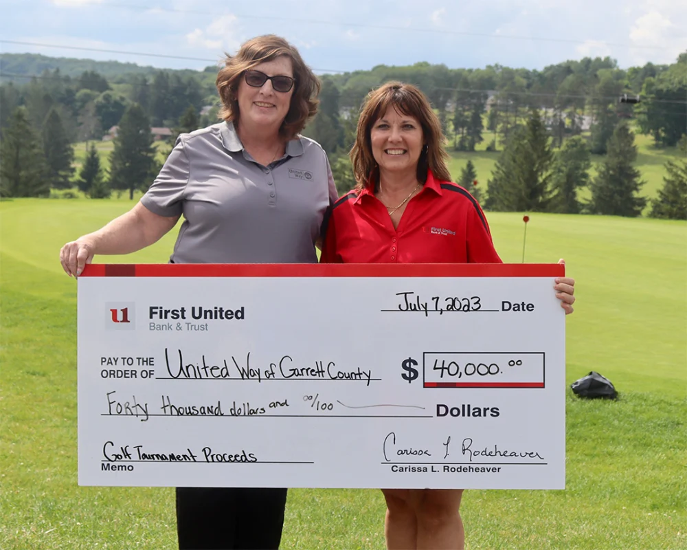 Carissa Rodeheaver, President & CEO, presents check to Michele Walker, Executive Director of County United Way