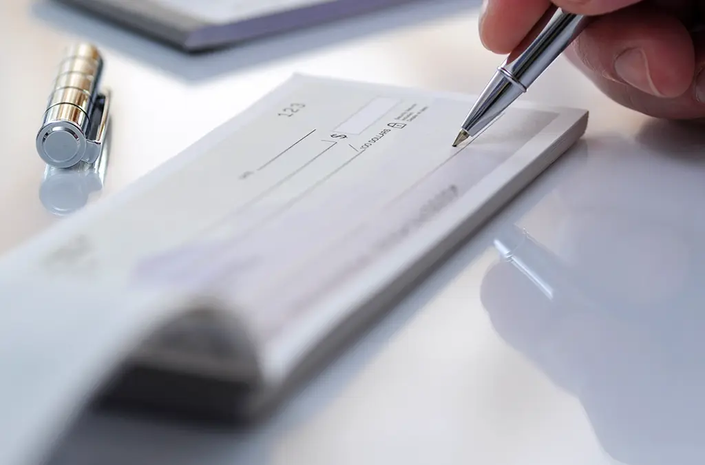 Person writing a check