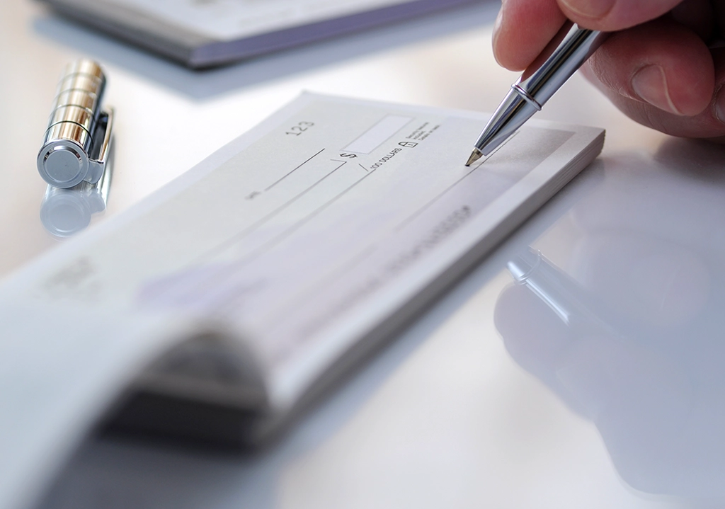 Person writing a check