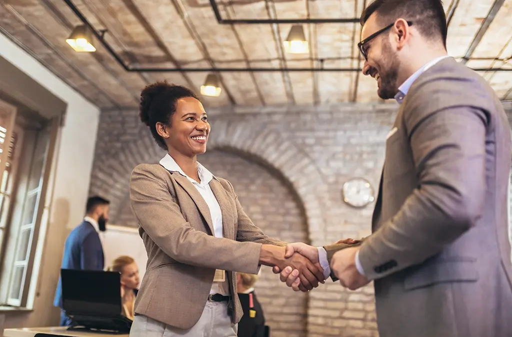 Man and woman shake hands