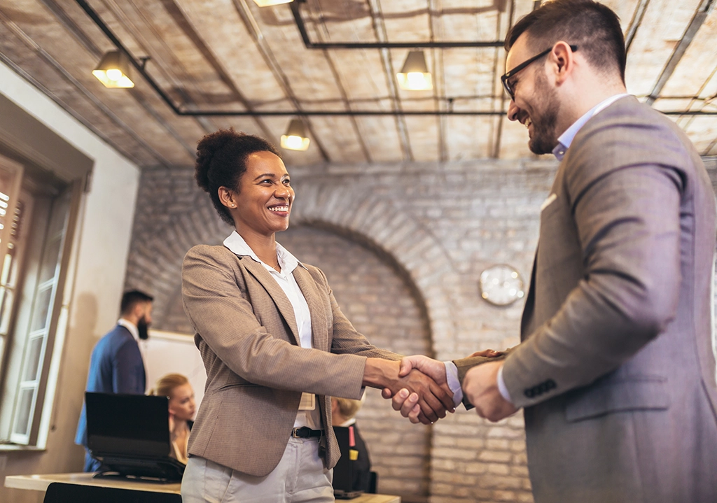 Man and woman shake hands