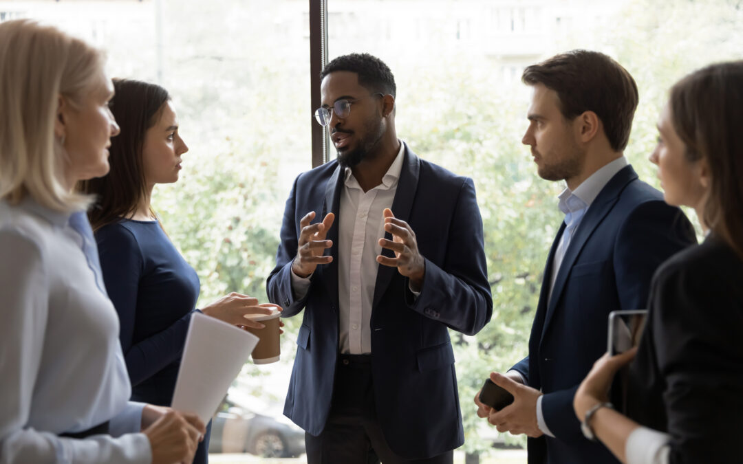 A confident business leader speaks to his employees.