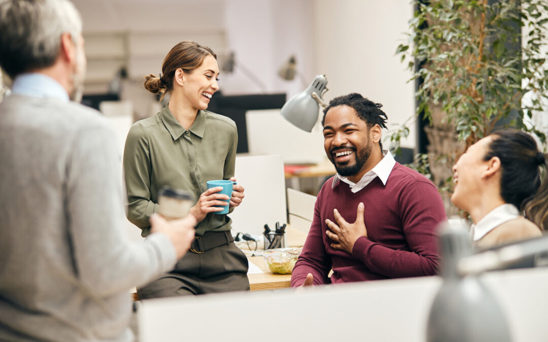 A group of happy employees smiling and working together.