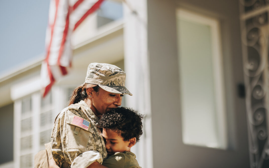 A service member embraces her son after returning from deployment.