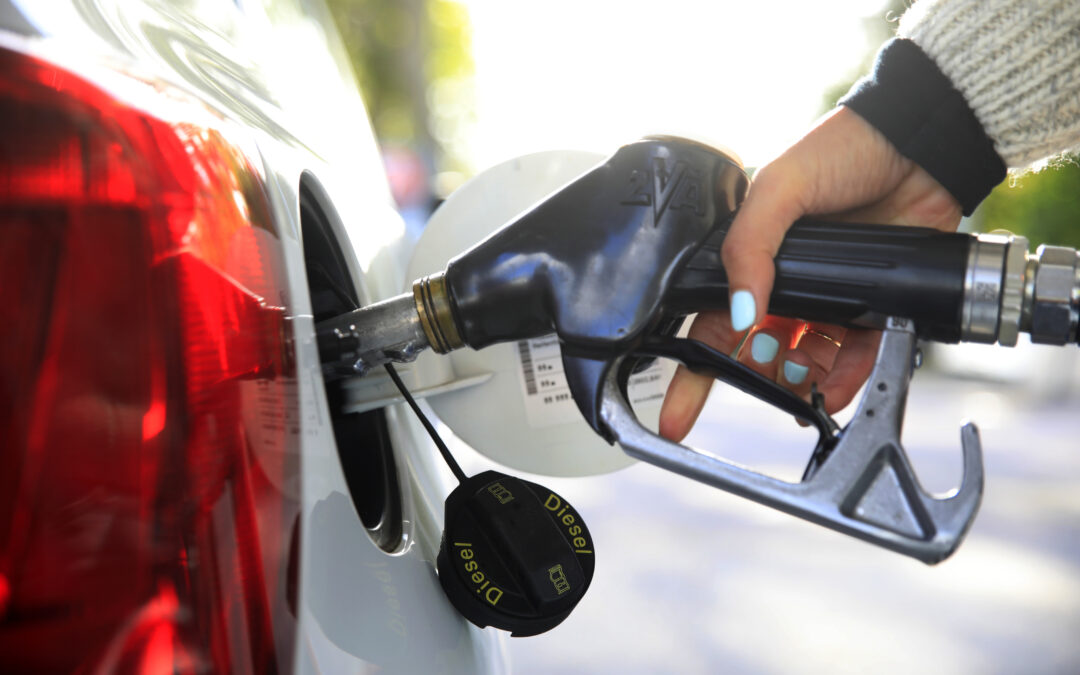 A person fills up their gas tank at the pump.