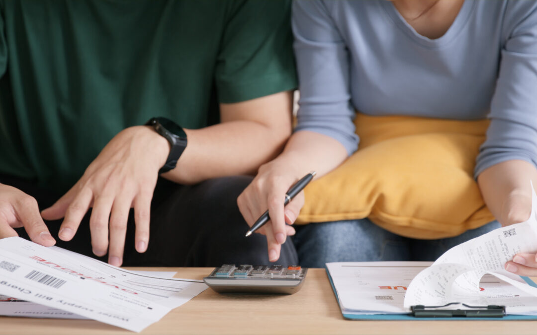 A married couple goes over their finances and expenses together.