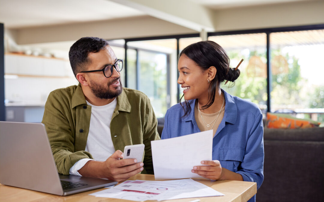 A man and woman talk about finances in their house.