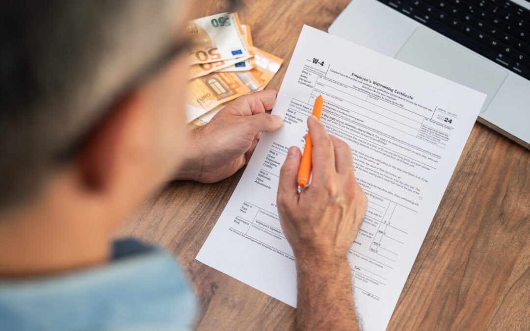 A business owner looks over tax documents for their employees.