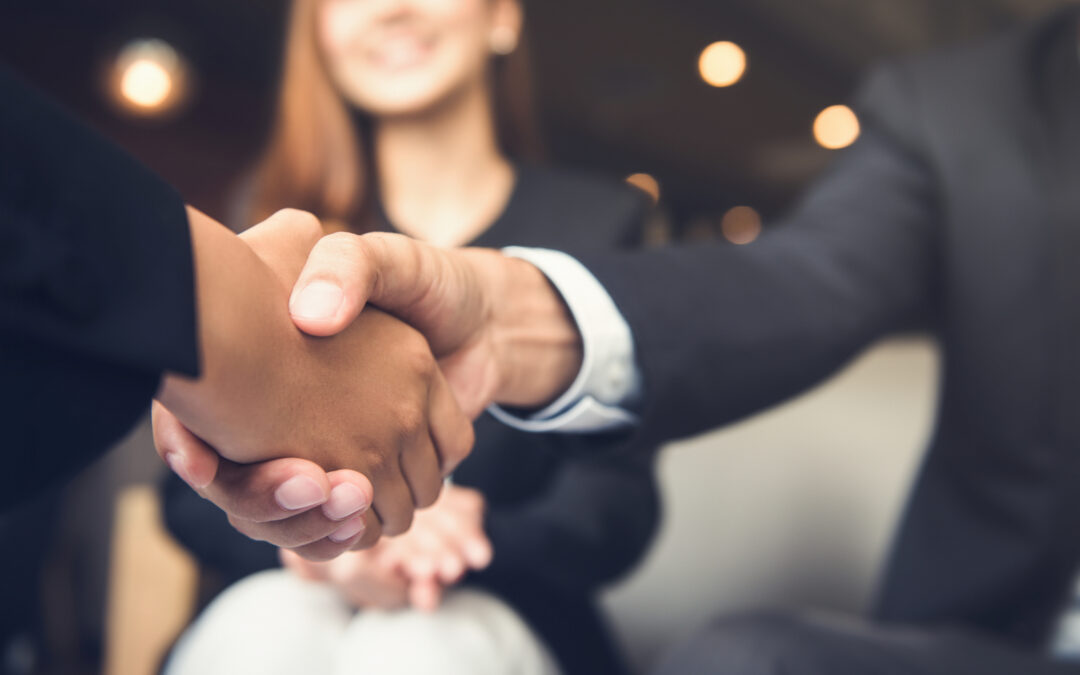 Two business professionals shaking hands.