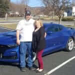 Photo of customers with new car